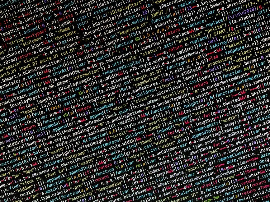 A black laptop with a red backlit keyboard displaying blurred lines of code on its screen, positioned on a flat surface in front of a plain background. To the right of the laptop, there is a white Pum
